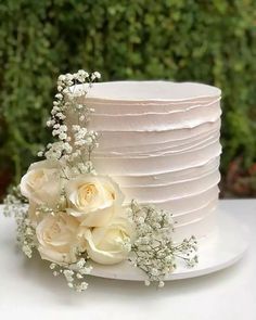 a white wedding cake with flowers on top