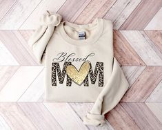 Blessed Mom Sweatshirt, Mom Shirt, Blessed Mama Sweater, Mama Shirt, Leopard Patterned Shirt, Gift For Mama, Blessed Mom Shirt, Gift For Her HOW TO ORDER 1-) Please, Check and Review all Photos. 2-) Choose your size and color from the drop-down menus. 3-) Choose your quantity. 4-) Prices listed are for one item. 5-) Your shipping will automatically combine when ordering multiples. 6-) Checkout out all at once when the correct size, color and quantity has been added. 7-) Finally, your custom shirt will be ready to ship 1-3 Business Day. Holiday times may affect the handling times. -Our shirts are made to order specially for you. Because of this reason we don't accept returns or exchanges. Please check our color and size charts before you place your order. If you have any questions please se Mama Sweater, Blessed Mama, Patterned Shirt, Mom Sweatshirt, Custom Shirt, Leopard Pattern, High Quality T Shirts, Mama Shirt, Mom Shirt