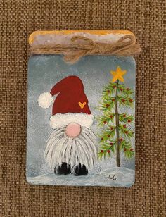 a small ceramic ornament with a santa clause on it