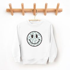 Looking for a cute sweatshirt for your kids? We have the perfect Checker Board Smiley Face graphic sweatshirt addition to their closet! Also available in toddler sweatshirts. White Long Sleeve Fun Sweatshirt, Playful White Long Sleeve Sweatshirt, Playful Cotton Sweatshirt With Graphic Print, Playful Crew Neck Hoodie For Fall, Cute White Sweatshirt With Graphic Print, Playful Long Sleeve Graphic Sweatshirt, Playful Graphic Print Long Sleeve Sweatshirt, Playful Crew Neck Sweater With Graphic Print, Playful Cotton Sweatshirt For Streetwear