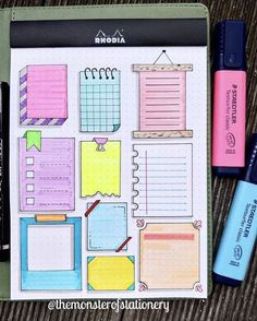 a notebook with sticky notes and markers on it