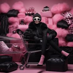 a woman sitting in a shopping cart surrounded by pink fur