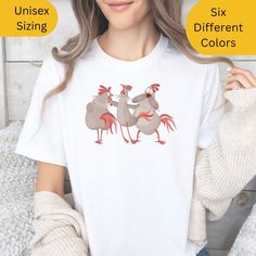 Look no further for the perfect gift for your silly best friend or couple! This funny Chicken T shirt is sure to get some laughs and be a hit with anyone who loves a good joke. Give the gift of laughter and fun with this silly best friend or couple gift shirt! Our shirts are from our BELLA AND CANVAS brand, this tee offers style and comfort. Here's what you need to know before you make your purchase: SHOP POLICIES * Unisex Adult Sizing. * Rolled Sleeves in pictures are for styling purposes only. * Props used in photos are NOT included with purchase. PRINT DESIGN * This is a Direct-To-Garment printed item, ensuring durability without cracking or peeling. * The ink is printed INTO the fabric, ensuring longevity. WASHING INSTRUCTIONS * Wash inside out, in cold water, on a gentle cycle. Tumble Funny Cotton Shirt Gift, Funny Cotton Shirt As Gift, Funny Cotton Shirt As A Gift, Fun Shirt With Funny Print For Gift, Novelty Tops With Funny Text For Gifts, Funny Print Shirt As Gift, Novelty Tops With Funny Text As Gift, Farm Tees, Chicken Shirt