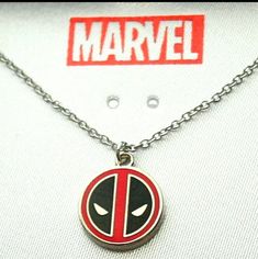 a deadpool necklace with the word marvel on it's front and back side