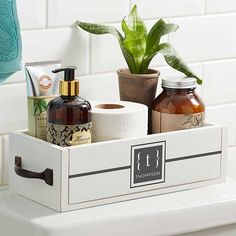 a bathroom shelf with soap, toiletries and a plant