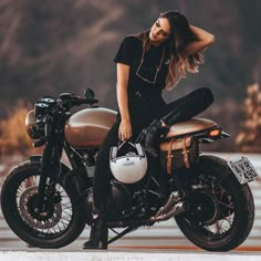 a beautiful woman sitting on top of a motorcycle