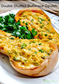 stuffed butternut squash on a white plate with parsley sprinkled around the edges