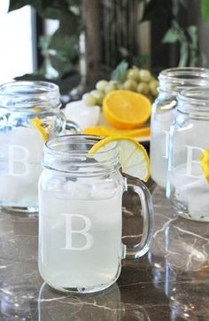 an image of drinks in mason jars with oranges and lemons on the side