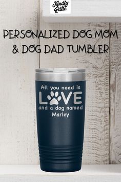 the personalized dog mom and dad tumbler is shown on a shelf with white wood background