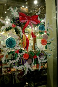 an image of a christmas window display with ornaments in the front and on the back