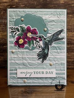 a card with a bird and flowers on it