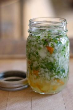 a jar filled with food sitting on top of a wooden table