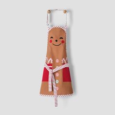 an oven mitt with a ginger on it hanging from a hook in front of a white wall