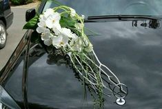 a bouquet of flowers is placed on the hood of a car