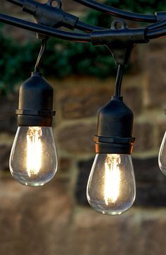 several light bulbs are hanging from a wire