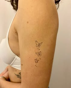 a woman with a butterfly tattoo on her arm