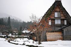 an old house with snow on the ground