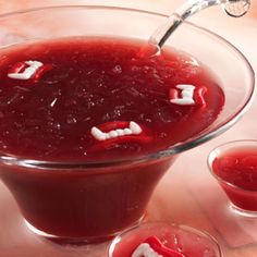 a glass bowl filled with red liquid on top of a table