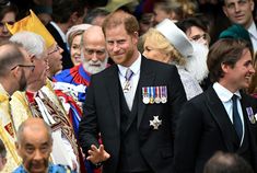 the prince and queen are walking through a crowd