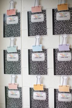 a bulletin board with several clips attached to it's sides and some writing on them