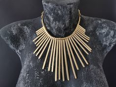 Ethnic Gold Plated Statement Necklace | Tribal Large Pendant Necklace | Bohemian Jewelry | Boho Chic Torque | Boho Jewelry | Gold Plated Jewelry Inspired by ancient tribal pieces mixed with a touch of modern design. Solid with a beautiful design this antique matte gold plated zamak necklace is a stunning piece, perfect to make everyone's attention turned on you. . Handmade Necklace * Gold Plated * Lead & Nickel free * Hypoallergenic * Has an adjustable chain, so you can arrange the length of Bohemian Bronze Necklaces For Party, Bronze Bohemian Necklace For Party, Bohemian Bronze Necklace For Parties, Silver Boho Jewelry, Silver Mask, Boho Chic Earrings, Large Pendant Necklace, Face Necklace, Silver Coat