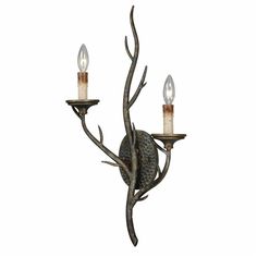 a candle holder with two candles on it and an animal head hanging from the wall