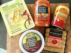 some food is sitting on top of a cutting board next to other foods and condiments