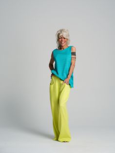 Light and fun, this versatile piece elevates every outfit. The delicate diamond pattern lends this piece a sleek and timelessly chic look. Tuck the sides into your pants of choice for an easy relaxed outfit. FEATURES:Patterned turquoise top with slits at the sides and a low V-line at the back.100% Handmade. SIZE & FIT:Fit: A relaxed fit with room to moveModel is wearing size Small or S/MView our SIZE CHART before ordering MATERIALS & CARE:Content: 95% Viscose, 5% ElastaneCare: Machine wash on cold (30ºC) with a mild detergent. SHIPPING:Made to order, processing time is 15 working daysThis item will be shipped via DHL Chic Turquoise Tops, Turquoise Top, Yellow Pants, Relaxed Outfit, Skirt Jumpsuit, Yellow Fabric, The Floor, Diamond Pattern, Skirt Pants