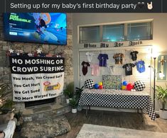 a baby's first birthday party is set up with toys and t - shirts