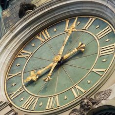 a large clock on the side of a building with roman numerals and stars