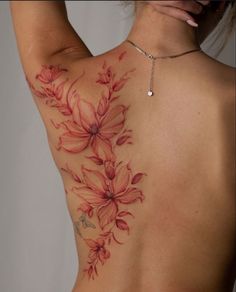 the back of a woman's body with flowers painted on her shoulder and chest