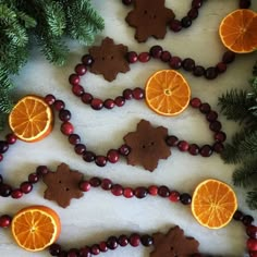 oranges, cranberries and cookies are arranged in the shape of bears on a table