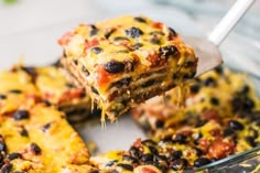 a piece of lasagna being lifted from a casserole dish