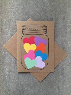 two cards with hearts in a mason jar