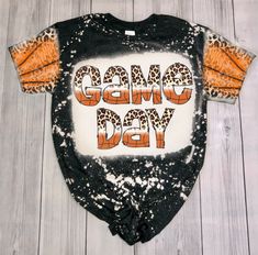 an orange and black shirt with the words omeg day written on it in leopard print