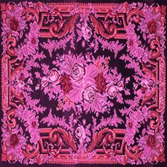 a pink and black square scarf with red flowers on the bottom, in an ornate design