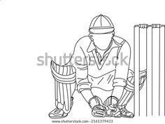 a man kneeling down next to a cricket bat