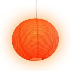 an orange paper lantern hanging from a ceiling