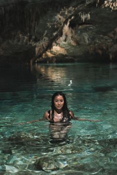 a woman in the water with her hands on her hips