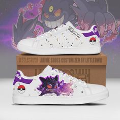 a pair of white sneakers with purple and black pokemon characters on them, sitting in front of a box