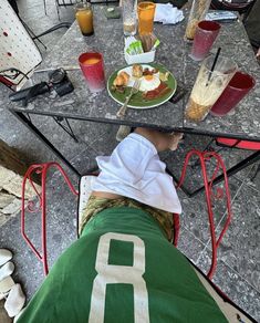 a person sitting at a table with food on it