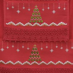 a red piece of cloth with a christmas tree on it