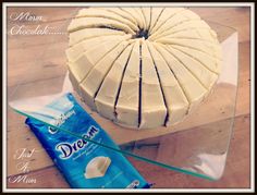 a cake sitting on top of a wooden table next to a bag of chocolate chips