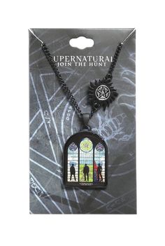 a necklace with an image of two people standing in front of a stained glass window