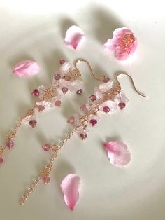 "There are many types of pink blossoms, but the pink cherry blossom - called 'sakura' in Japanese - are some of the most breathtaking. I've added tiny little faceted rondelles of various shades of pink tourmaline, from rubellite to soft pink, and nestled them into smooth chips of rose quartz on 14K rose gold-filled chain and findings, to give that impression of the delicate pink blossoms with dark pink centers. The Sakura earrings are 3.25\" in length, from rose gold-filled earhooks. You can cus Pink Flower Crystal Earrings, Elegant Pink Petal-shaped Earrings, Pink Gemstone Flower-shaped Jewelry, Pink Gemstone Flower-shaped Earrings, Pink Gemstone Earrings In Flower Shape, Pink Gemstone Earrings With Flower Shape, Pink Dangle Flower Earrings Gift, Pink Dangle Flower Earrings For Gift, Dainty Pink Flower-shaped Earrings