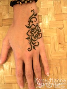 a woman's hand with a tattoo on it