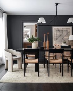 a dining room table with chairs and a vase on it