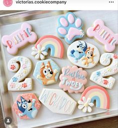 some cookies are on a tray with the words paw patrol and other decorated cookies in them