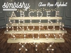 a wooden shelf with letters and lights on it that spell out the word simlishy class rose alphabet