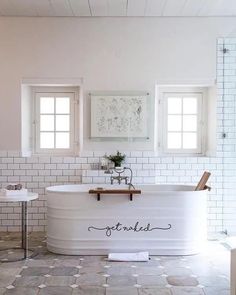 a bath tub sitting in the middle of a bathroom